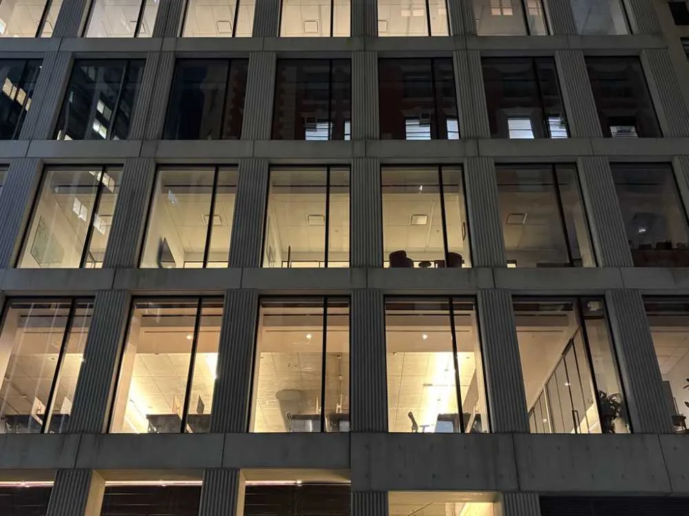 An office tower at night with ordinary drop ceilings and boxy vents